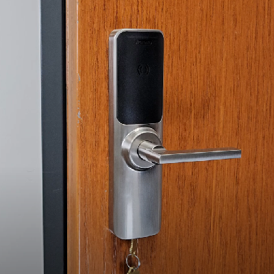 An electronic lock installed on a wooden door.